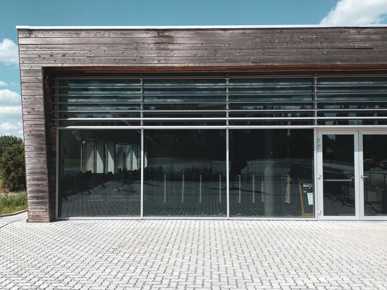 Demaeght Zonwering plaatste aan een voetbal kantine te Diegem Brussel deze structurele zonwering van Renson. Vliegtuiglamellen van Renson type Icarus 200 QuickFix onder 60°. Zonwerend maar laat het licht toch toe in de kantine. Modern en strak design zonder onderhoud. Architectural design. Een realisatie voor Eiffage Pit architecten.
